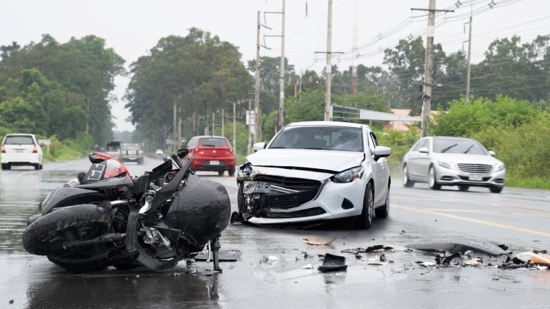 Accident with the motocycle or big bike and car in bad weather driving with falling rain