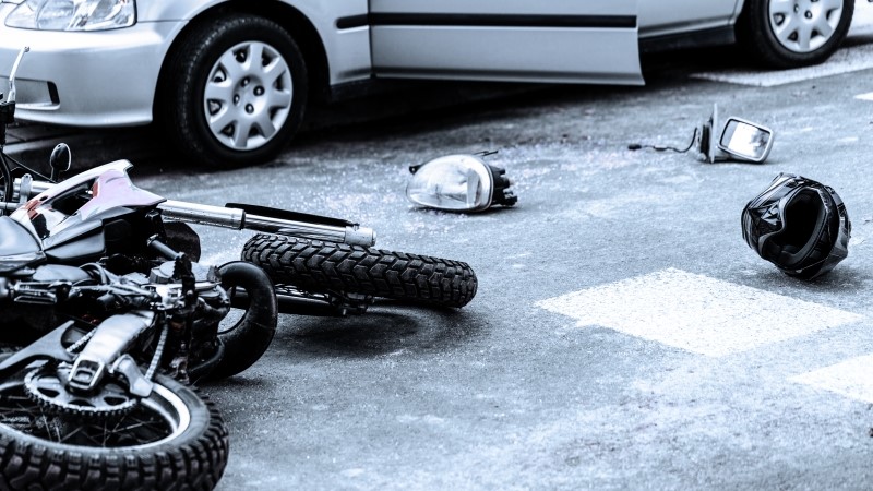 Motorcycle and car after terrible accident on the road