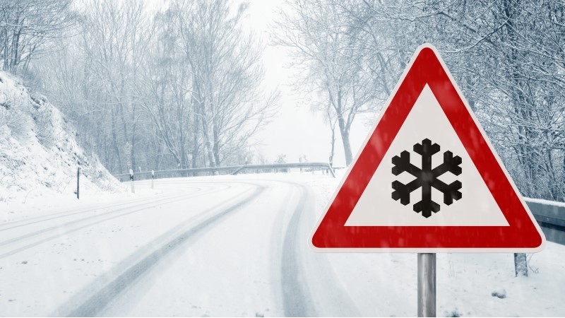 winter driving - winding country road in winter - risk of snow and ice