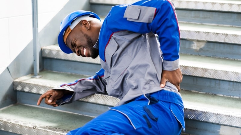 Worker Man Lying On Staircase After Slip And Fall Accident