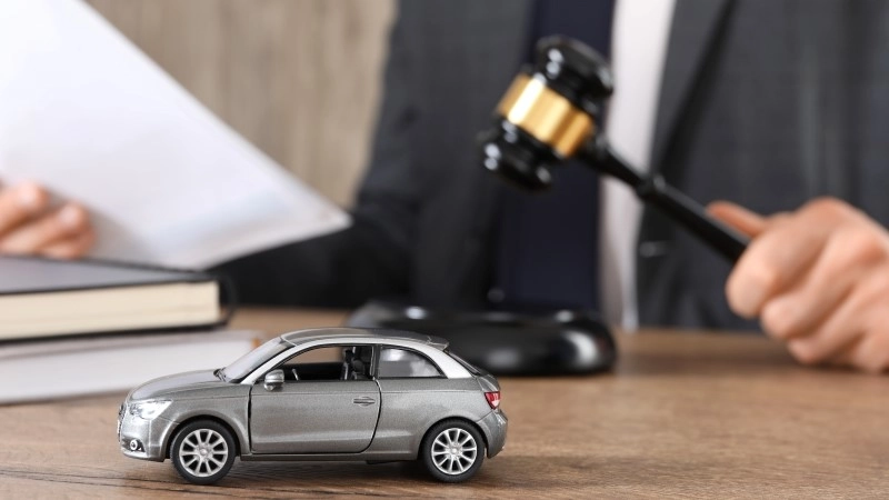 Auto accident law. Man with document and gavel at wooden table indoors,