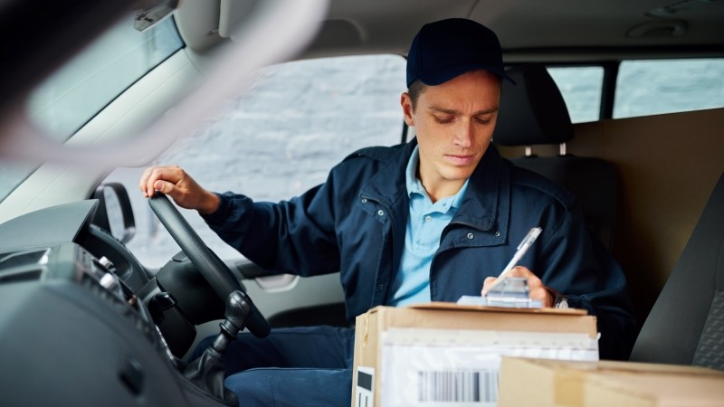 Male employee, clipboard and dispatch invoice, delivery schedule and transportation.