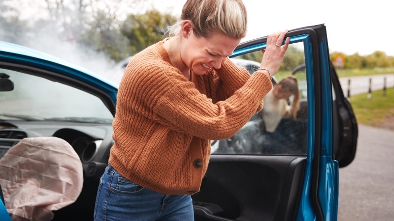 Female Motorist In Crash For Crash Insurance Fraud Getting Out Of Car