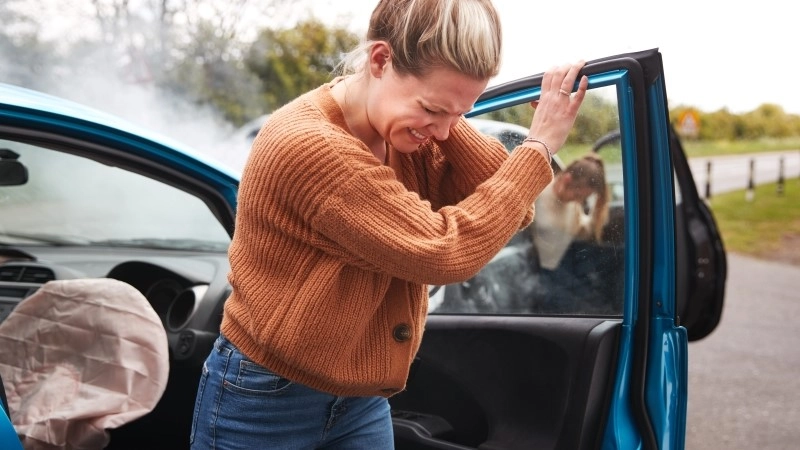 Female Motorist In Crash For Crash Insurance Fraud Getting Out Of Car