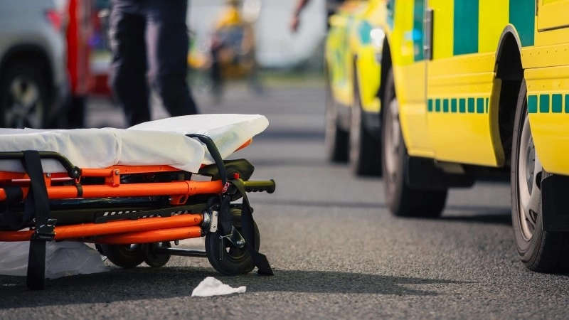 Selective focus on stretcher against ambulance cars of emergency medical service,