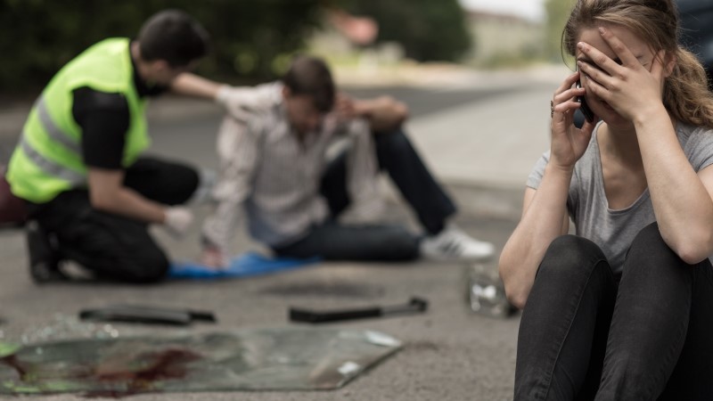 Despair young female driver after traffic accident