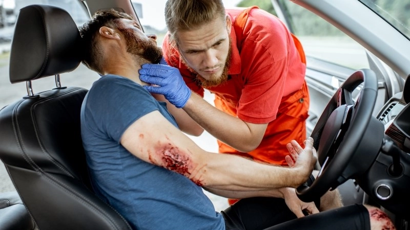 Medic examinig bleeding victim