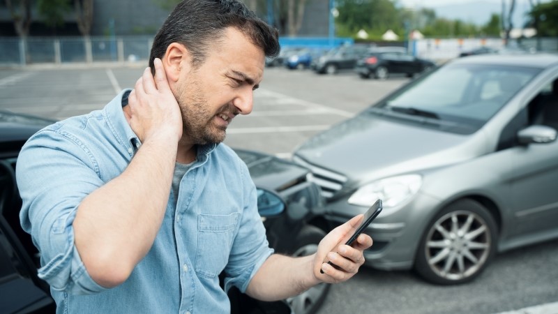 One man suffering pain after car crash injury calling first aid emergency