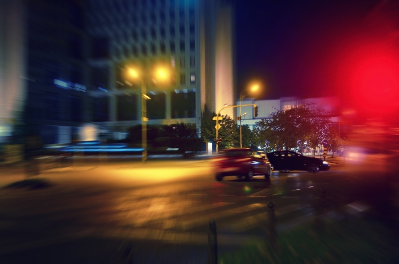 Car running through red light on the intersection and hitting another car. Car collision. Be safe.