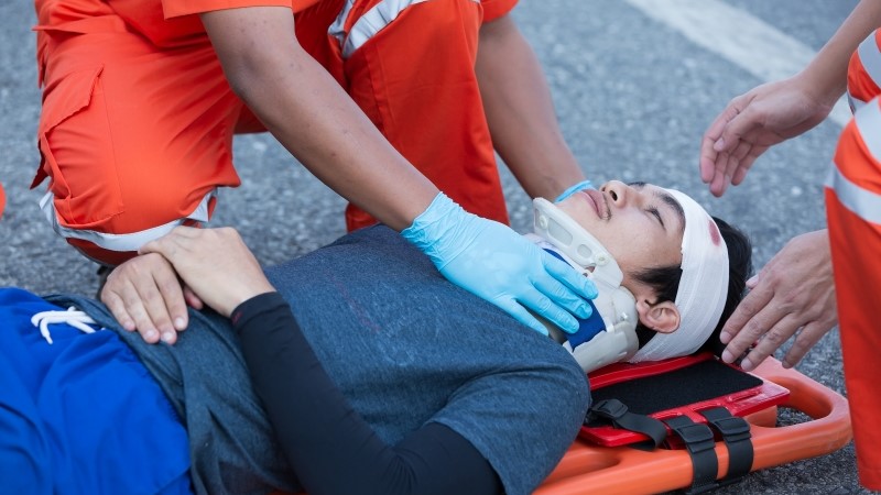 Injured man on patient transport stretcher.