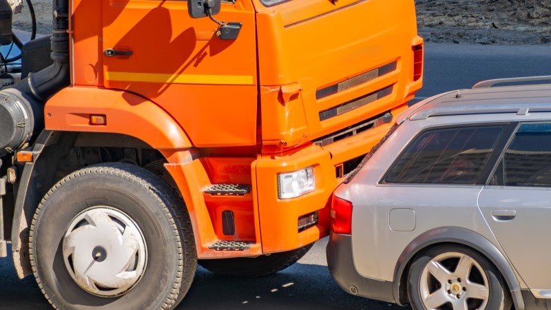 car accident between an orange truck and a passenger car. traffic accident.
