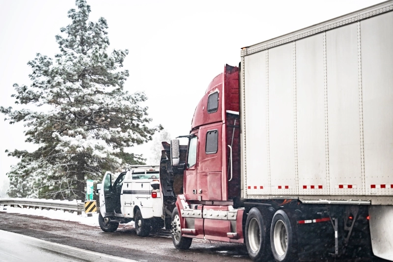 Broken big rig semi truck with open hood and semi trailer standing out of service