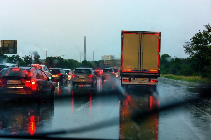 Danger of a traffic jam in heavy rain. Severe weather on the highway and bad driving conditions.