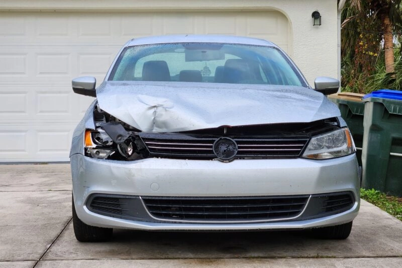 Dented,Car,Damaged,After,Traffic,Accident,Parked,On,Private,Home
