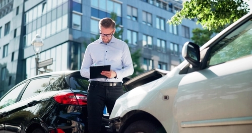 Insurance Agent Assessing Car Crash Damage in Dayton Ohio