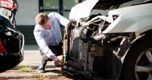 Insurance Agent Inspecting Rear-End Collision Damage Sarasota