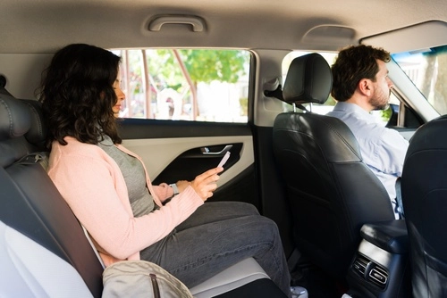Philadelphia Rideshare Passenger Using Smartphone in Backseat